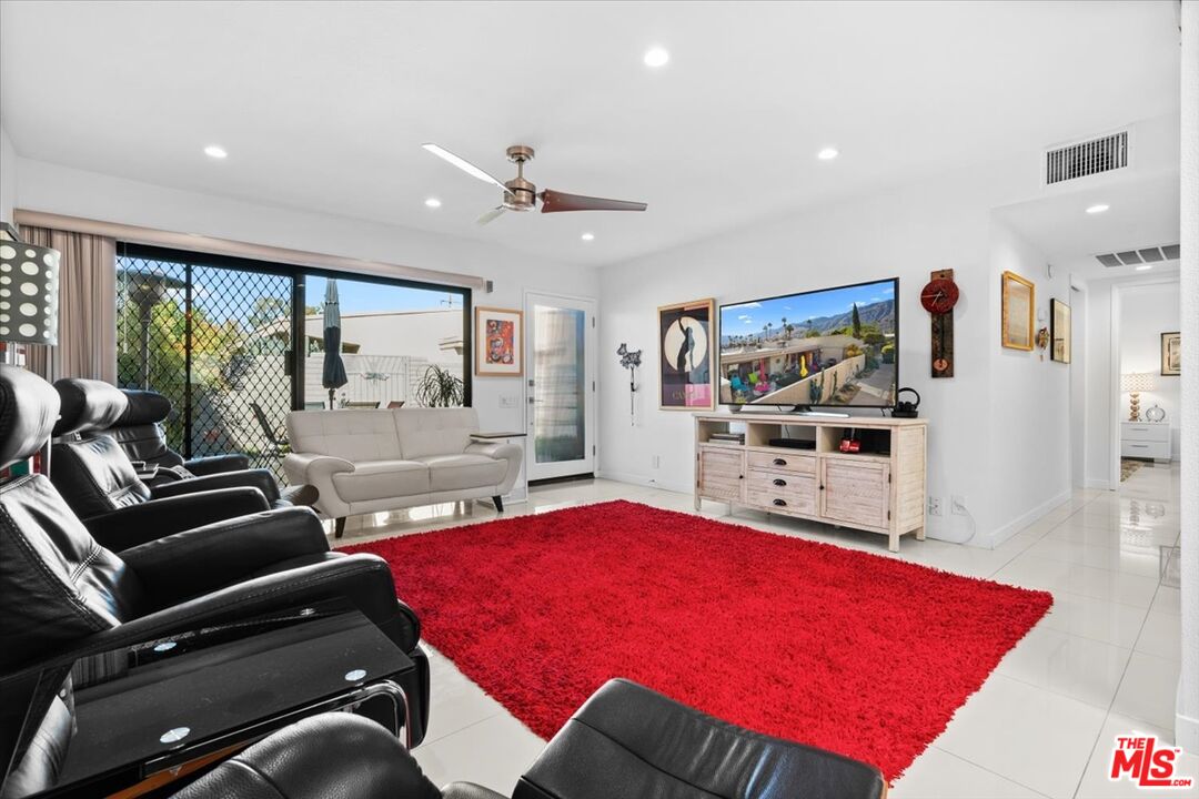 1111 East Ramon Road, Unit 17 Palm Springs, CA 92264 - Photo 4 of 34 a living room with furniture pool table and a flat screen tv
