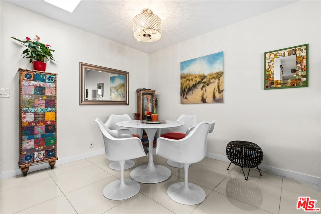 1111 East Ramon Road, Unit 17 Palm Springs, CA 92264 - Photo 7 of 34 a view of a dining room with furniture and wooden floor