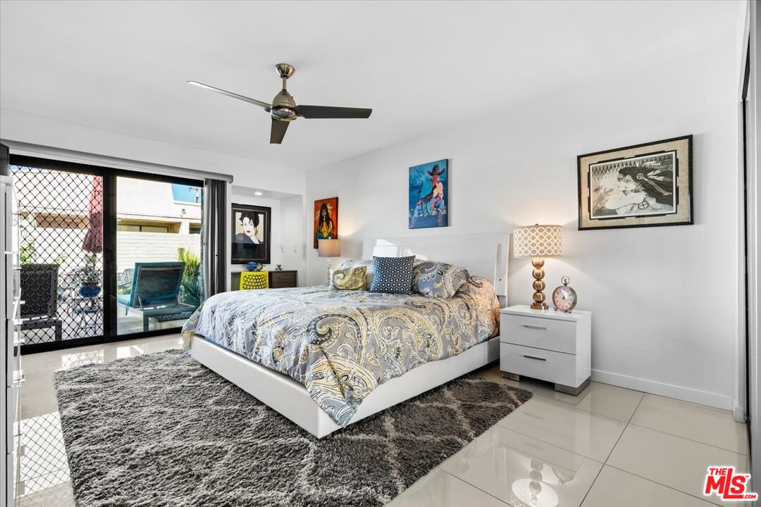 1111 East Ramon Road, Unit 17 Palm Springs, CA 92264 - Photo 8 of 34 a spacious bedroom with a bed and large window