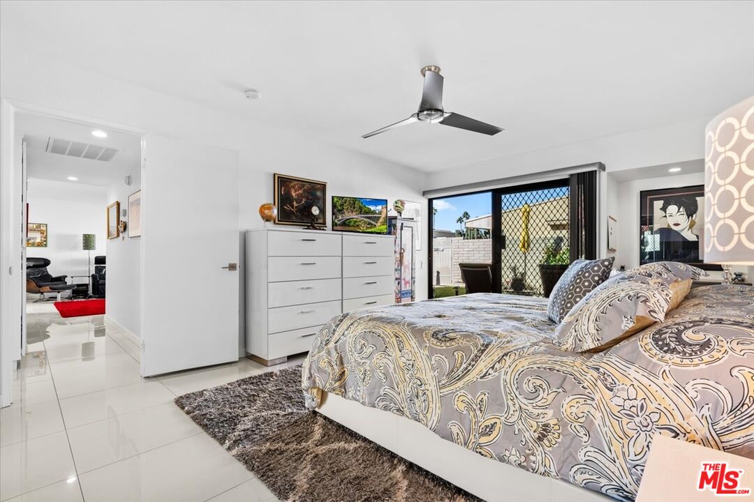 1111 East Ramon Road, Unit 17 Palm Springs, CA 92264 - Photo 9 of 34 a bedroom with a large bed and closet