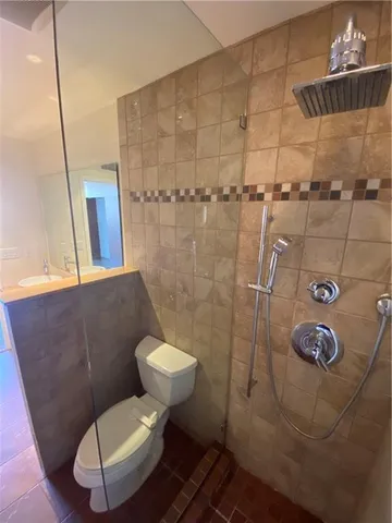 a bathroom with a toilet and a shower