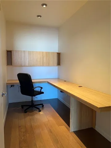 a view of a street with wooden fence