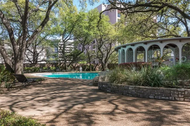 a view of a house with a yard patio and fire pit