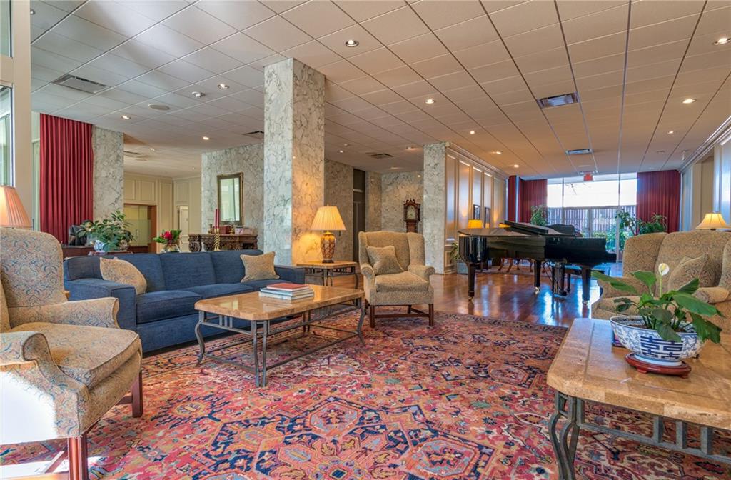 1801 Lavaca Street, Unit 2G Austin, TX 78701 - Photo 20 of 20 a living room with furniture and a dining table with kitchen view