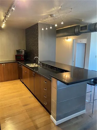 a kitchen with kitchen island a counter top space appliances and a ceiling fan