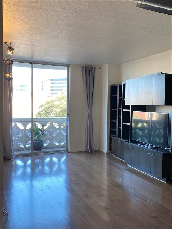 1801 Lavaca Street, Unit 2G Austin, TX 78701 - Photo 3 of 20 a view of empty room with wooden floor and fan
