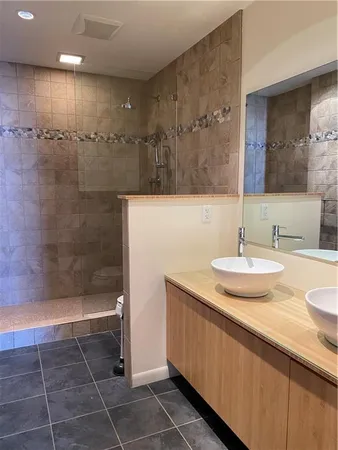 a bathroom with a sink a toilet and a mirror