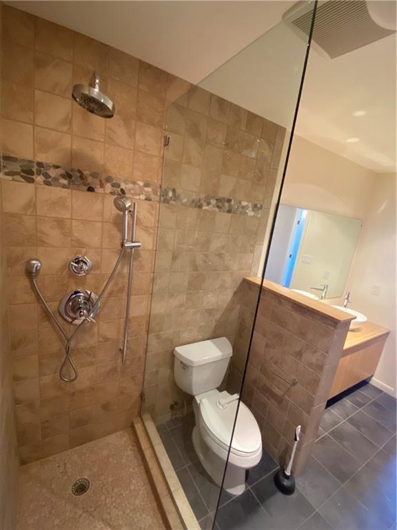 1801 Lavaca Street, Unit 2G Austin, TX 78701 - Photo 8 of 20 a bathroom with a shower and toilet
