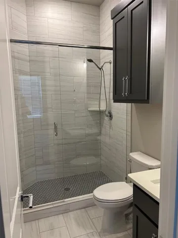 a bathroom with a shower and a toilet
