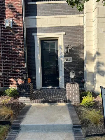 a couple of potted plants in front of door