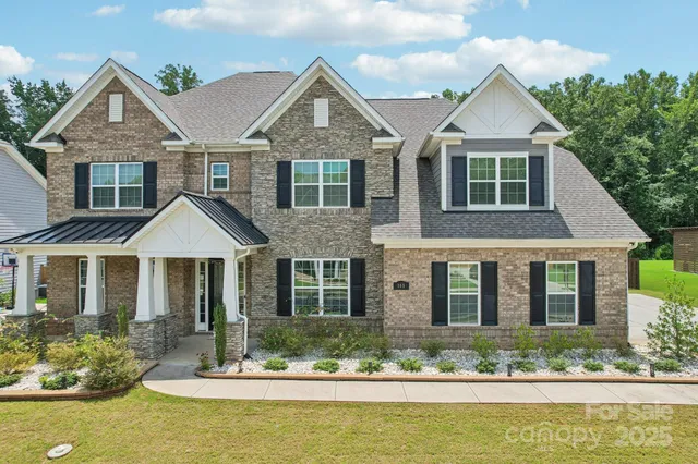a front view of a house with a yard swimming pool and outdoor seating