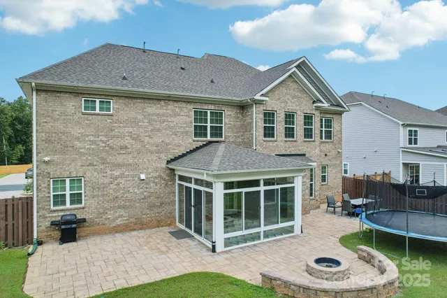 a view of a house with a yard and barbeque oven