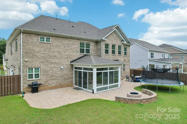 a front view of a house with a garden and yard