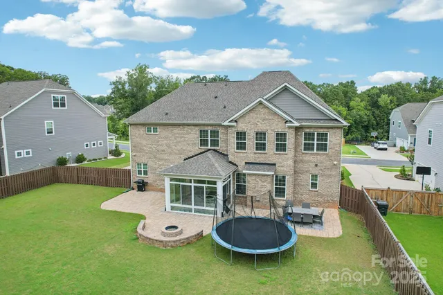a front view of a house with garden and patio