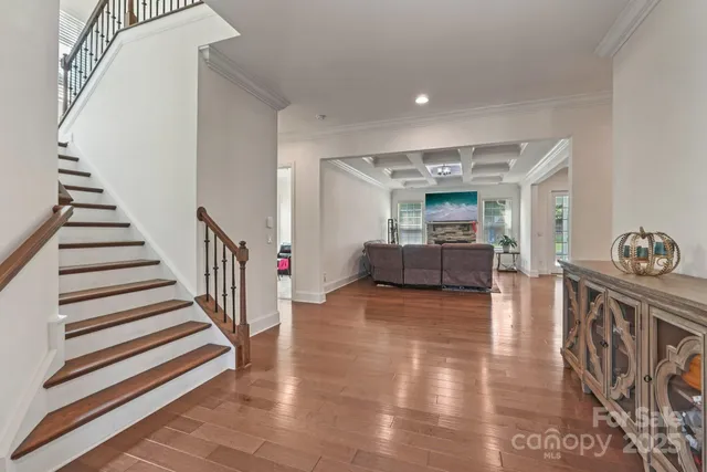 a living room with furniture and stairs