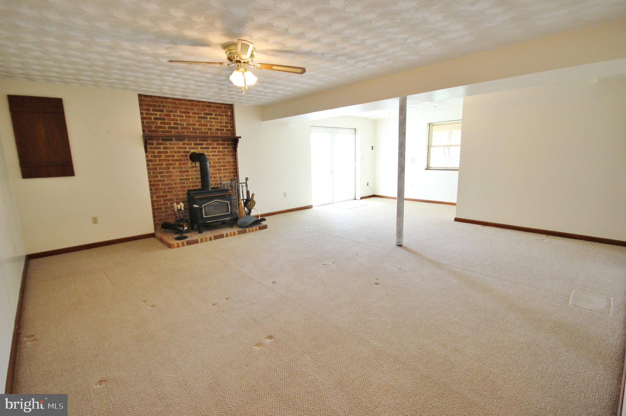 312 Granny Smith Road Linden, VA 22642 - Photo 32 of 59 Finished basement area with wood stove