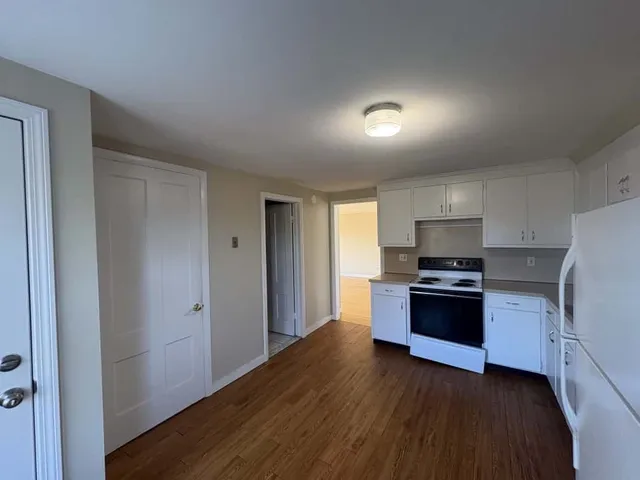 a kitchen with stainless steel appliances granite countertop a stove a refrigerator and a sink