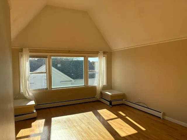 a living room with a bed and a window