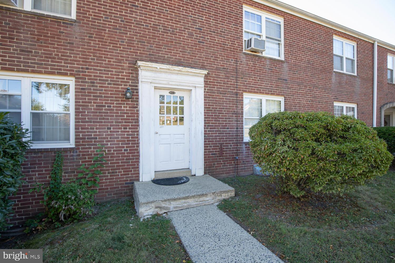 200 Maplewood Drive, Unit CONDO 4 Pottstown, PA 19464 - Photo 2 of 8 a view of a brick house with a yard