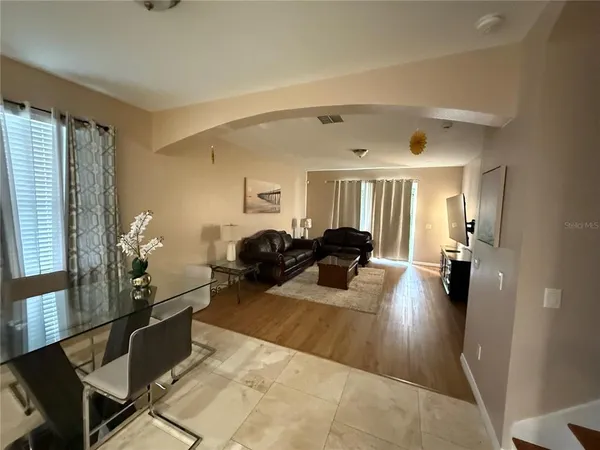 a living room with furniture and a wooden floor