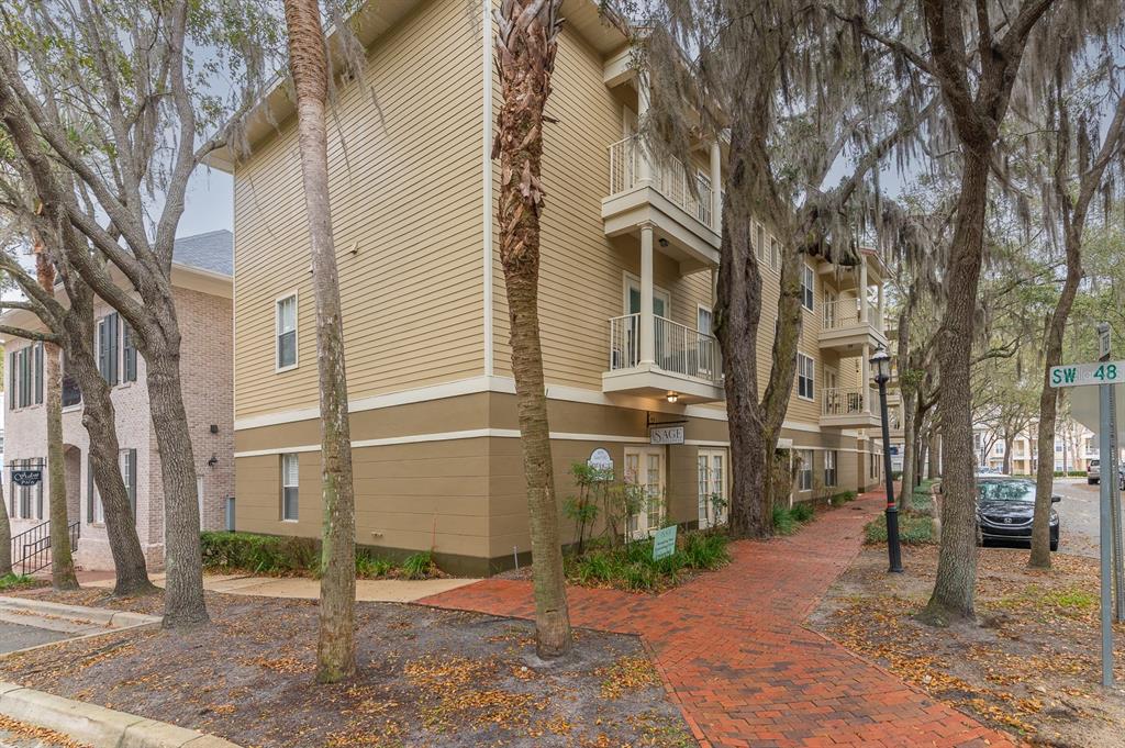 4850 Southwest 91 Terrace, Unit 301 Gainesville, FL 32608 - Photo 1 of 24 a brick building with a street