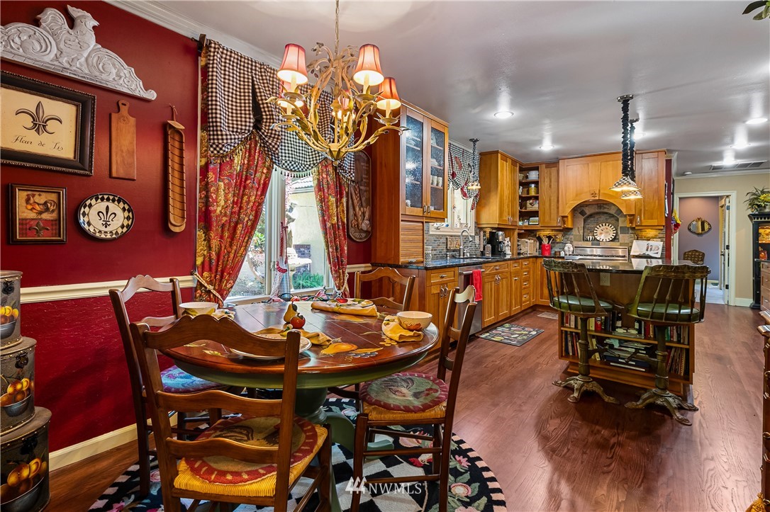 654 Clark Road Bellingham, WA 98225 - Photo 21 of 40 a view of a dining room with furniture and chandelier