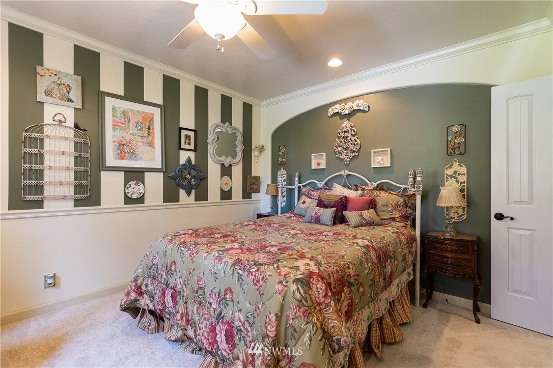 654 Clark Road Bellingham, WA 98225 - Photo 31 of 40 a bedroom with a large bed and a large window