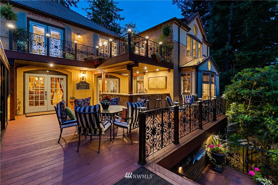 654 Clark Road Bellingham, WA 98225 - Photo 6 of 40 a view of a roof deck with table and chairs with wooden floor and fence