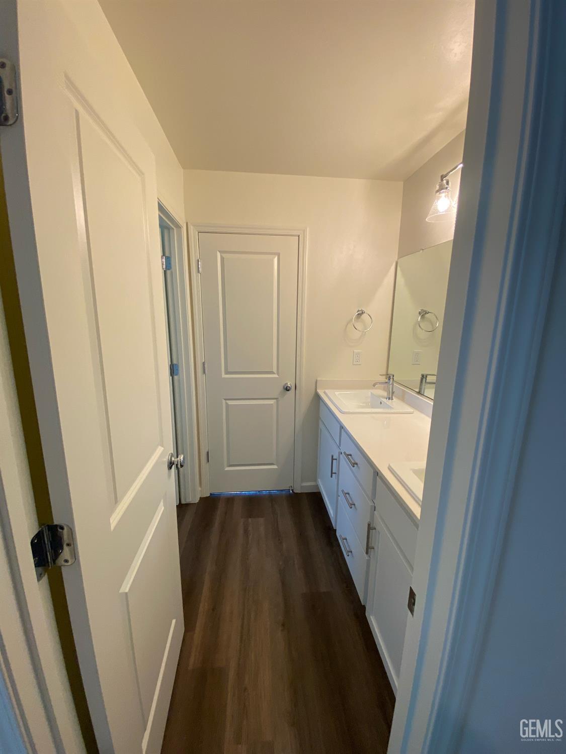 Undisclosed Address Bakersfield, CA 93313 - Photo 13 of 26 a bathroom with a double vanity sink and a mirror