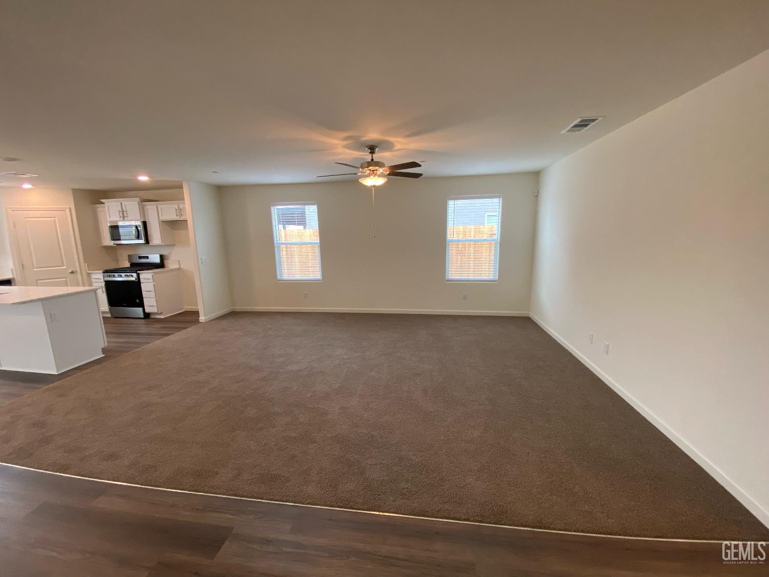 Undisclosed Address Bakersfield, CA 93313 - Photo 14 of 26 an empty room with windows and ceiling fan