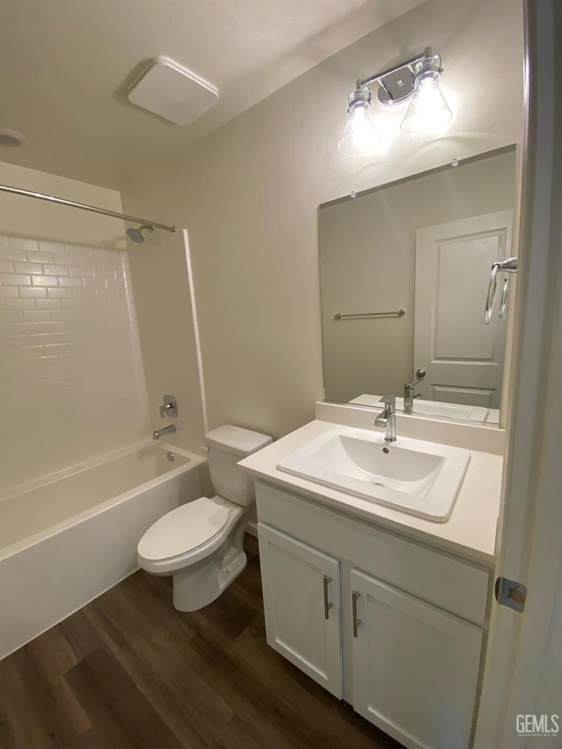 Undisclosed Address Bakersfield, CA 93313 - Photo 19 of 26 a bathroom with a sink a toilet a mirror a bathtub and shower