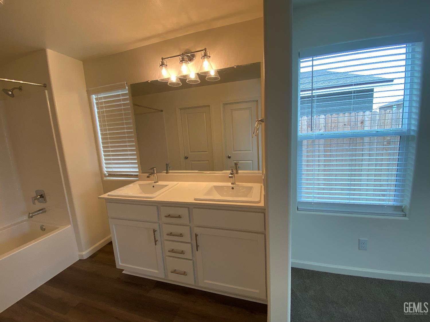 Undisclosed Address Bakersfield, CA 93313 - Photo 23 of 26 a bathroom with a granite countertop sink and a mirror
