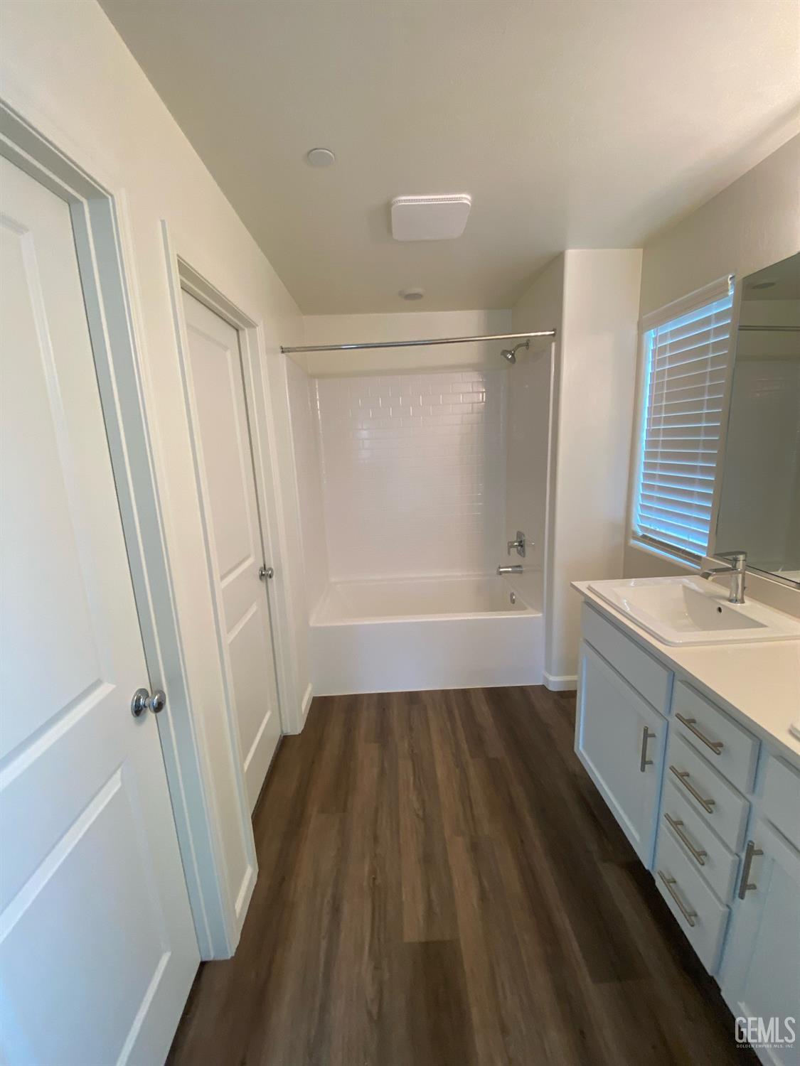 Undisclosed Address Bakersfield, CA 93313 - Photo 25 of 26 a bathroom with a sink a mirror and a bathtub