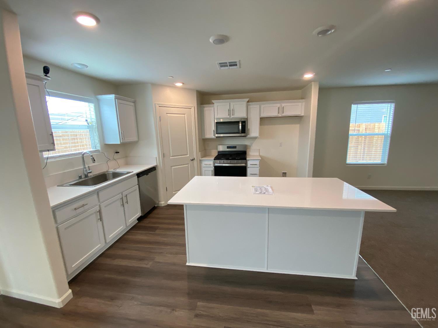 Undisclosed Address Bakersfield, CA 93313 - Photo 26 of 26 a large kitchen with kitchen island a sink a center island stainless steel appliances and a window