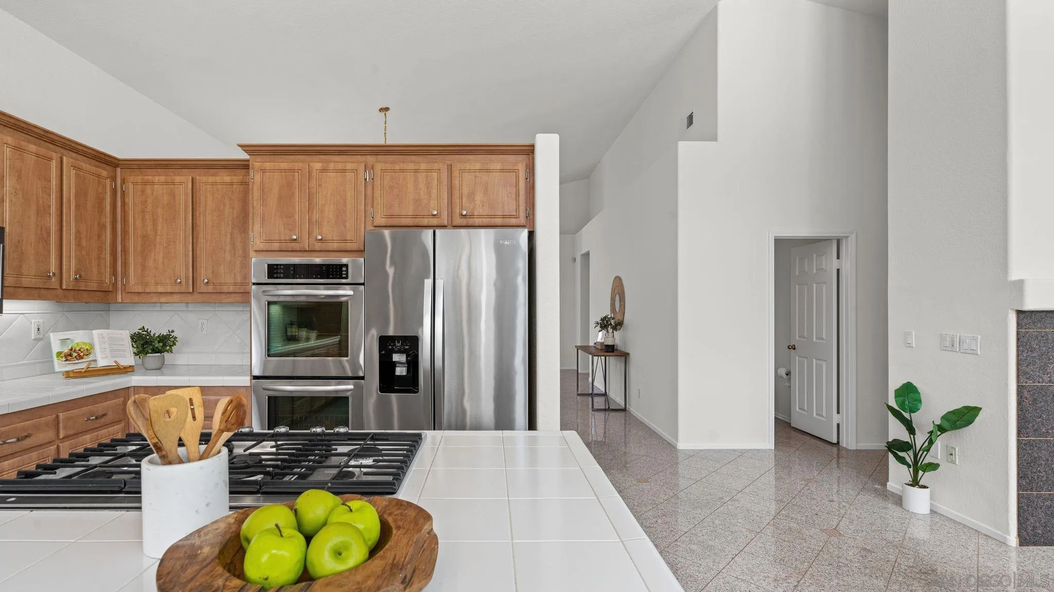 1783 Medinah Road San Marcos, CA 92069 - Photo 11 of 39 a kitchen with stainless steel appliances granite countertop a refrigerator a stove and a sink