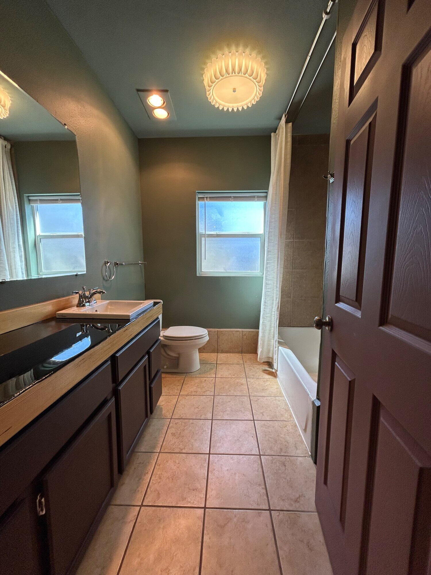 3118 37th Street, Unit FRONT Lubbock, TX 79413 - Photo 11 of 16 a kitchen with a sink a stove and cabinets