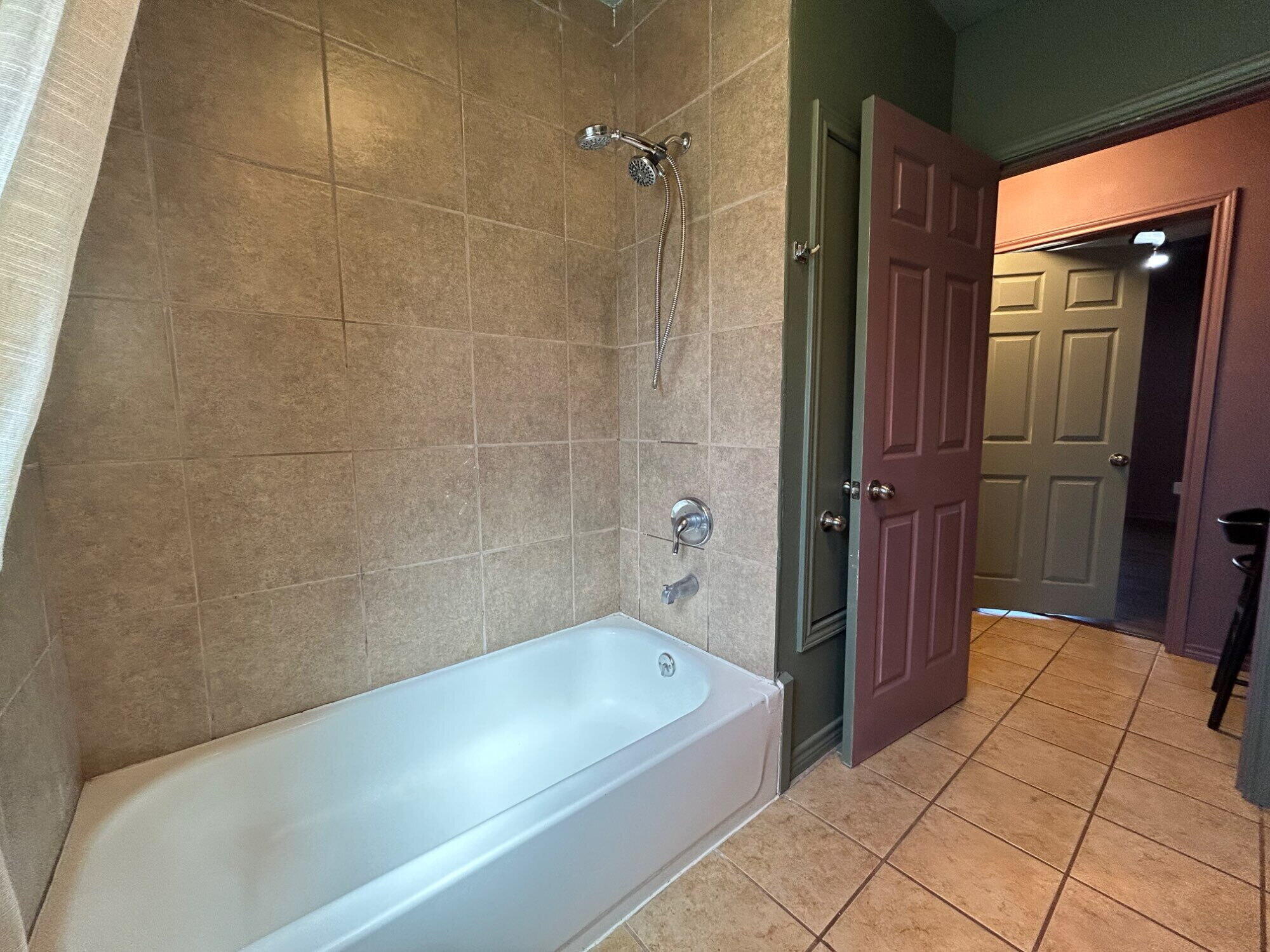 3118 37th Street, Unit FRONT Lubbock, TX 79413 - Photo 13 of 16 a bathroom with a bathtub and a shower