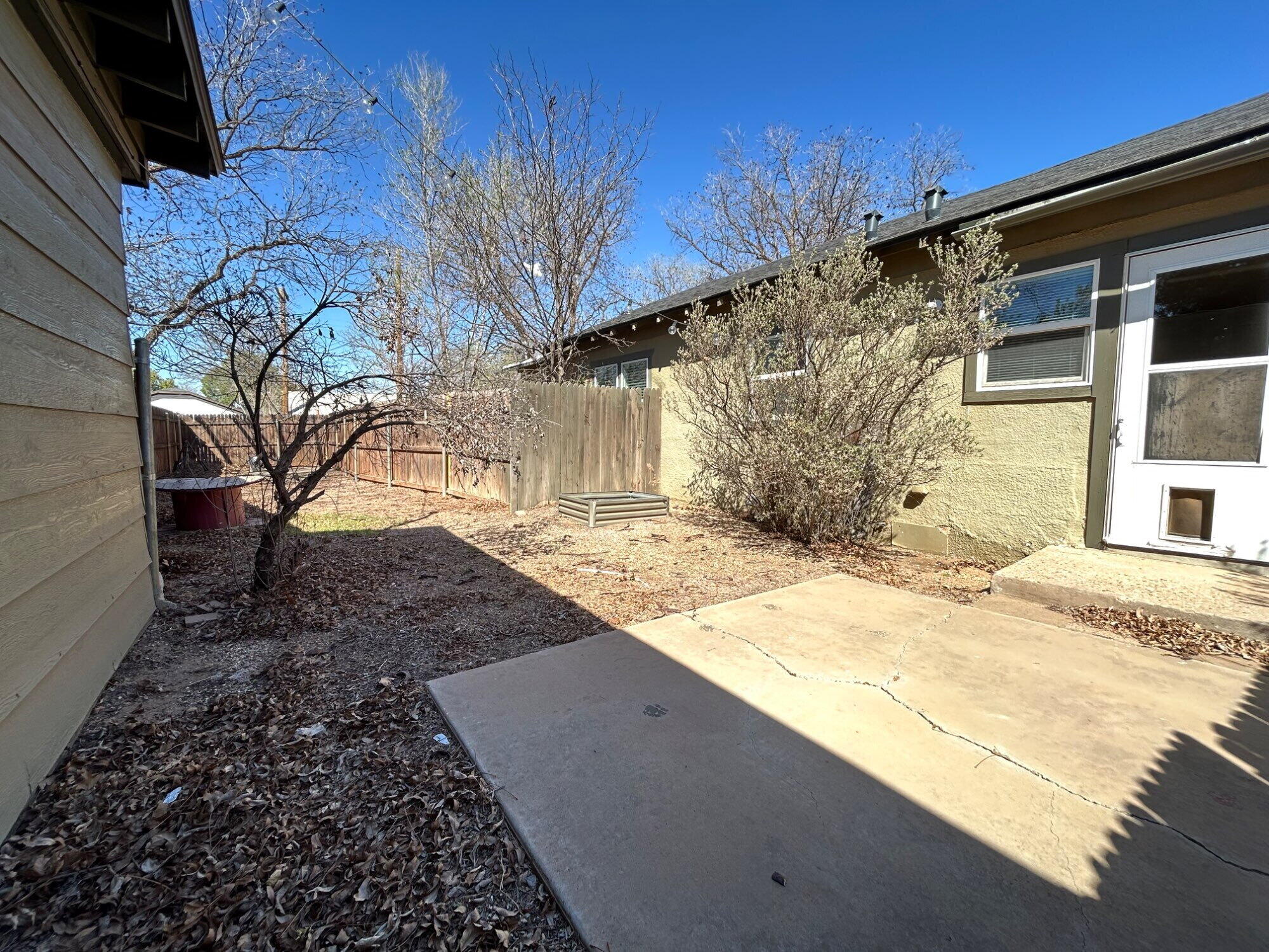 3118 37th Street, Unit FRONT Lubbock, TX 79413 - Photo 15 of 16 a view of a backyard of the house