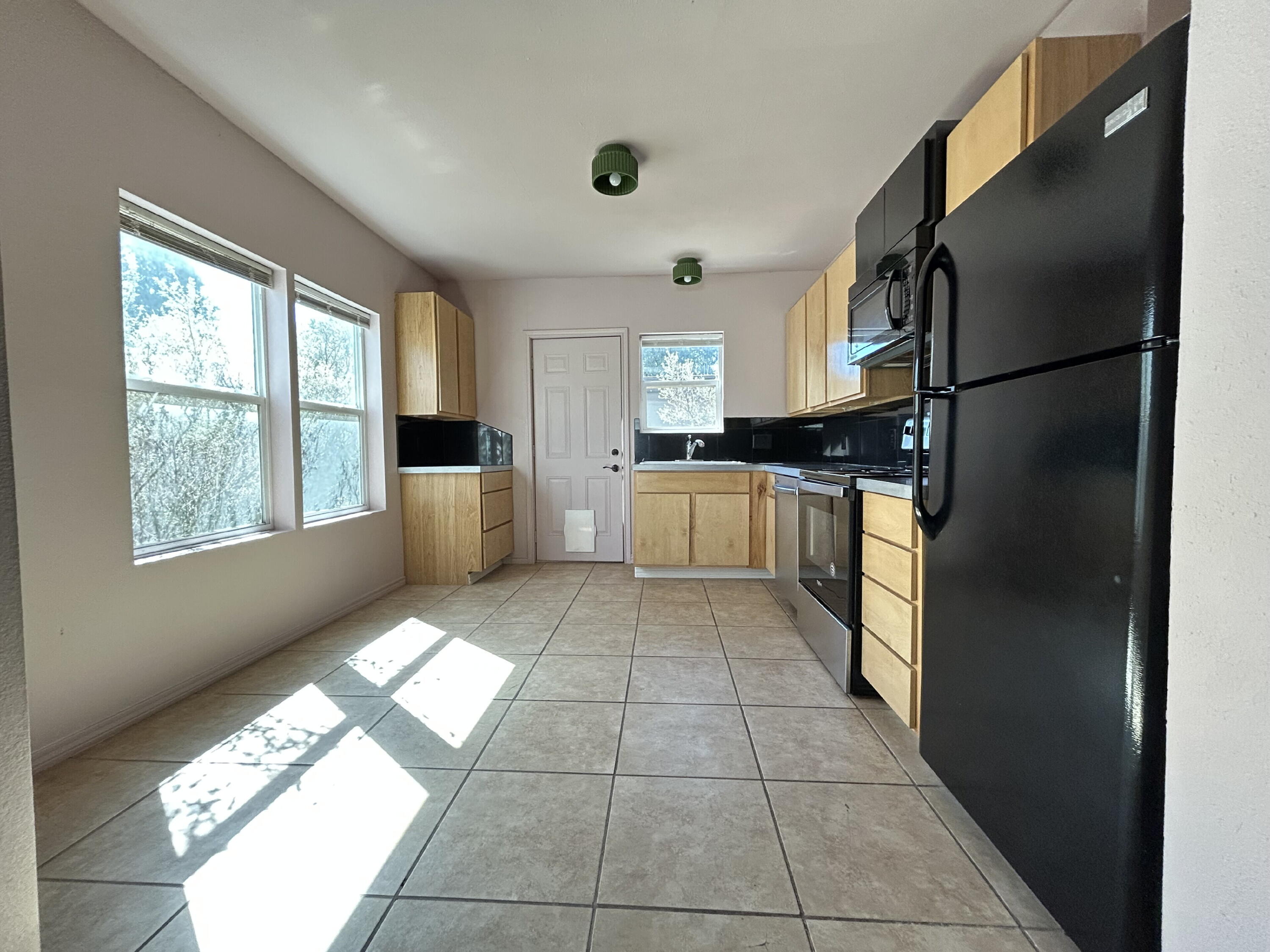3118 37th Street, Unit FRONT Lubbock, TX 79413 - Photo 4 of 16 a kitchen with stainless steel appliances granite countertop a refrigerator and a sink