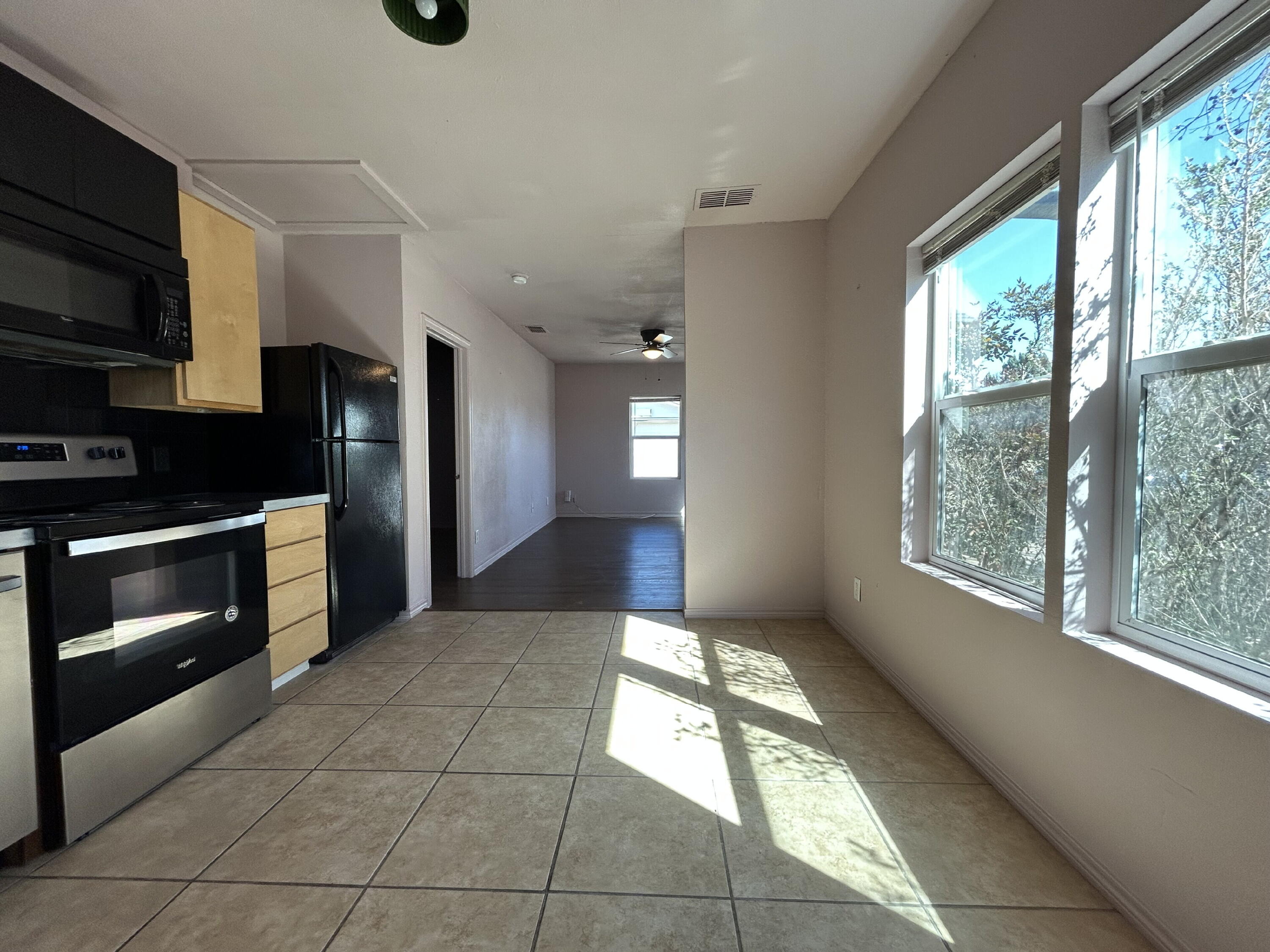 3118 37th Street, Unit FRONT Lubbock, TX 79413 - Photo 5 of 16 a view of a kitchen with an empty room and window