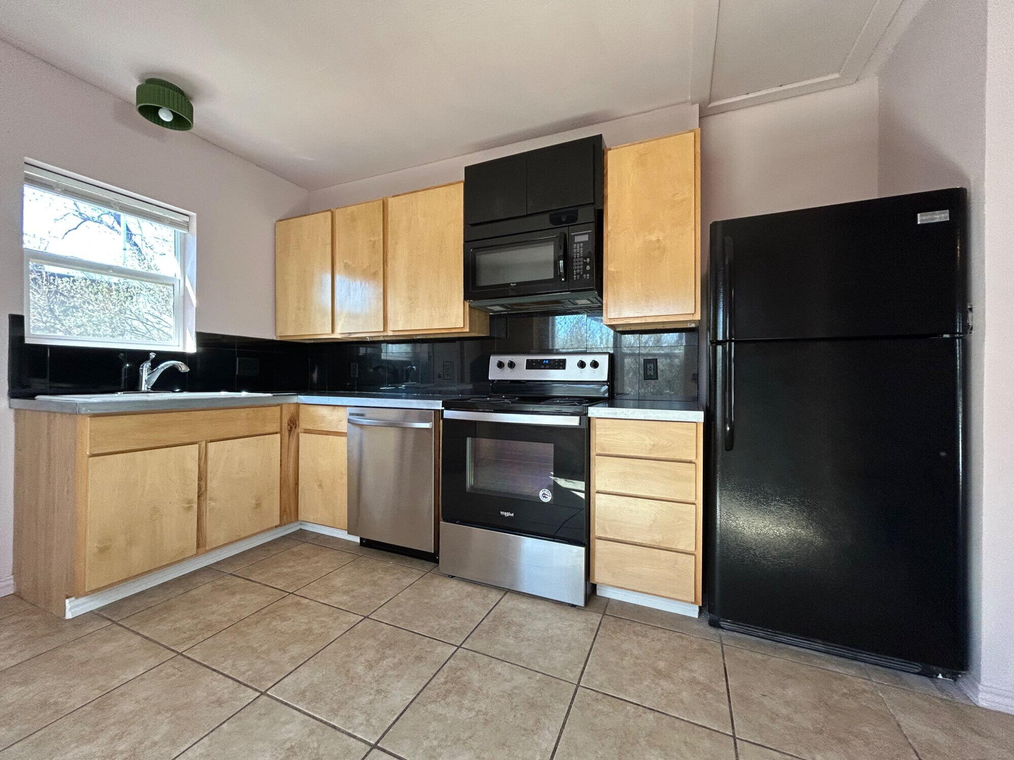 3118 37th Street, Unit FRONT Lubbock, TX 79413 - Photo 6 of 16 a kitchen with white cabinets and appliances