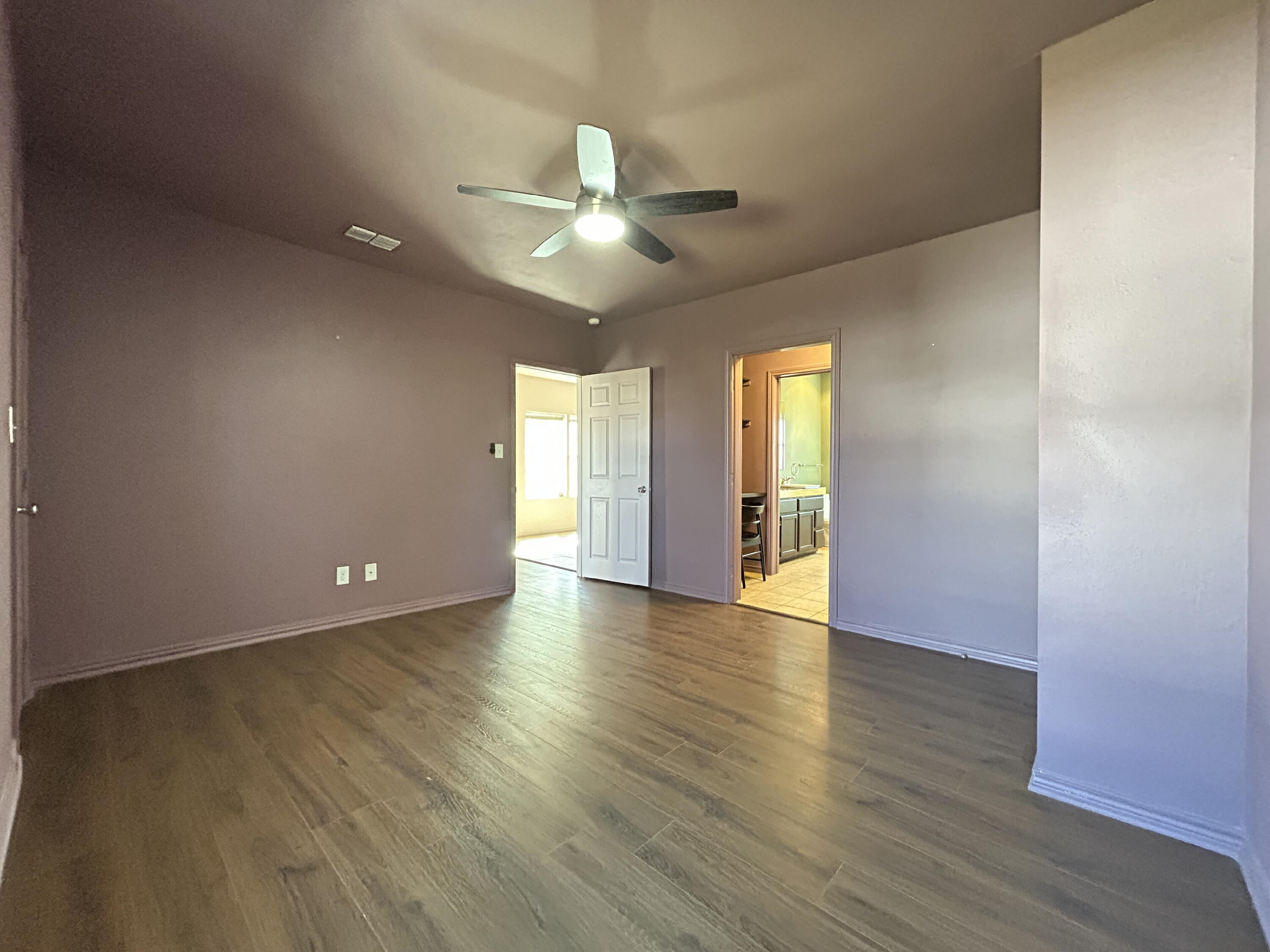 3118 37th Street, Unit FRONT Lubbock, TX 79413 - Photo 8 of 16 an empty room with wooden floor and windows