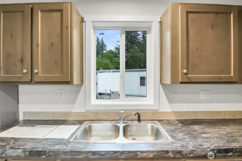 a kitchen with stainless steel appliances granite countertop a refrigerator stove top oven and sink