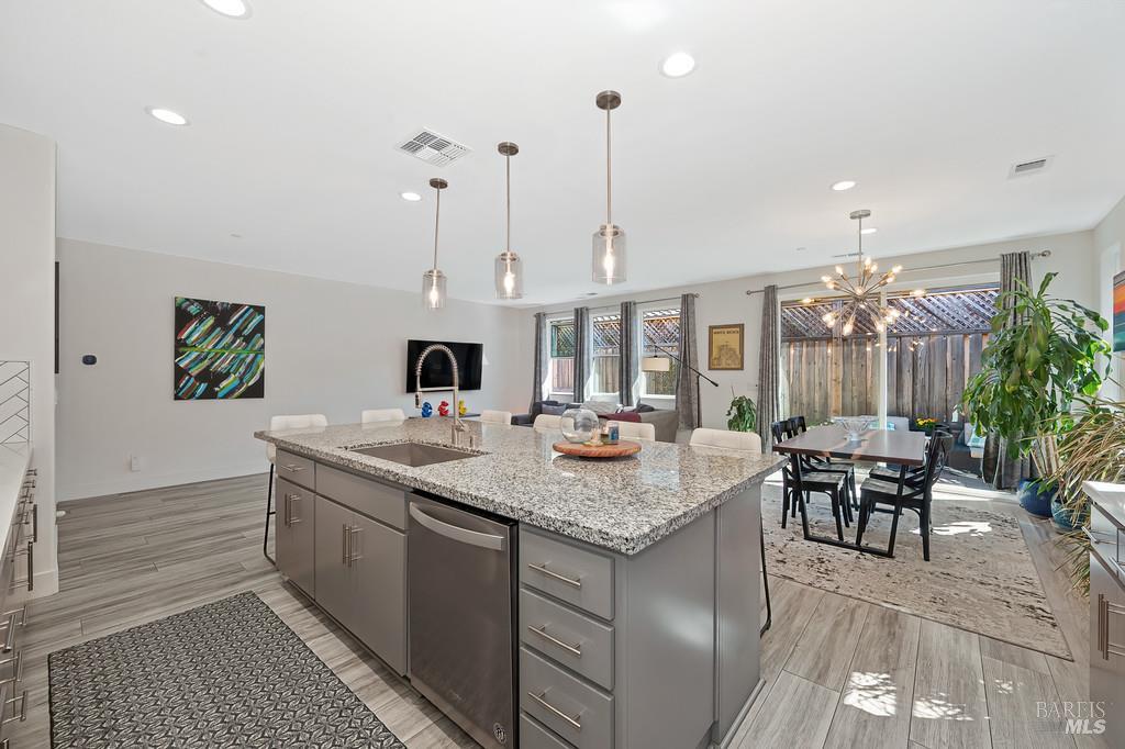 5708 Kassandra Place Rohnert Park, CA 94928 - Photo 16 of 45 a view of kitchen island with stainless steel appliances granite countertop sink and stove