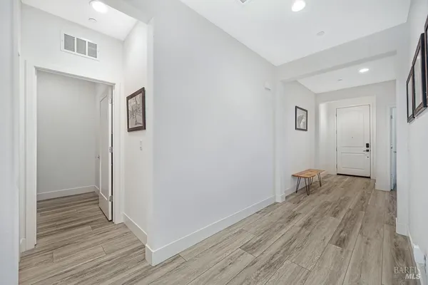 a view of a room with wooden floor