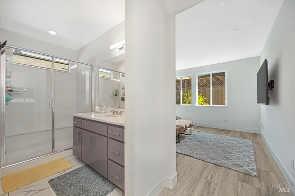 a bathroom with a tub sink and mirror