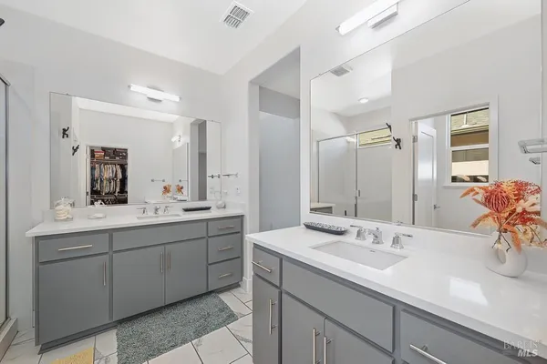 a bathroom with 2 sink and a mirror