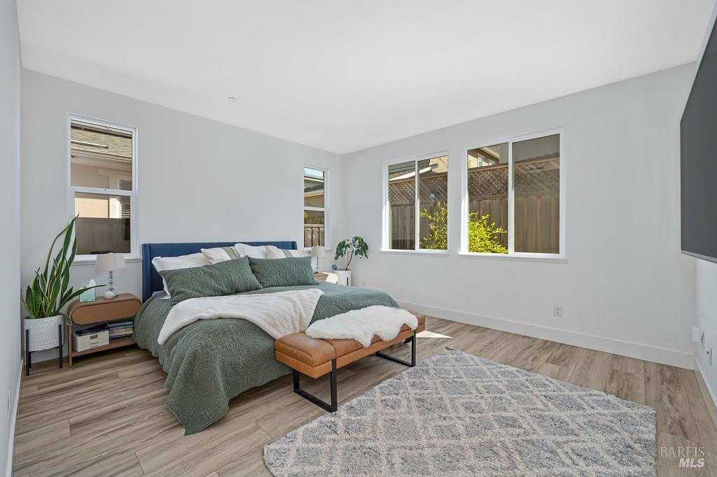 5708 Kassandra Place Rohnert Park, CA 94928 - Photo 33 of 45 a spacious bedroom with a bed and wooden floor