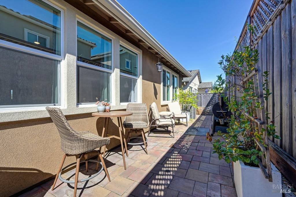 5708 Kassandra Place Rohnert Park, CA 94928 - Photo 40 of 45 a view of a patio with table and chairs potted plants and floor to ceiling window