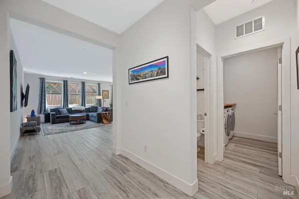a view of a livingroom with furniture and hardwood floor